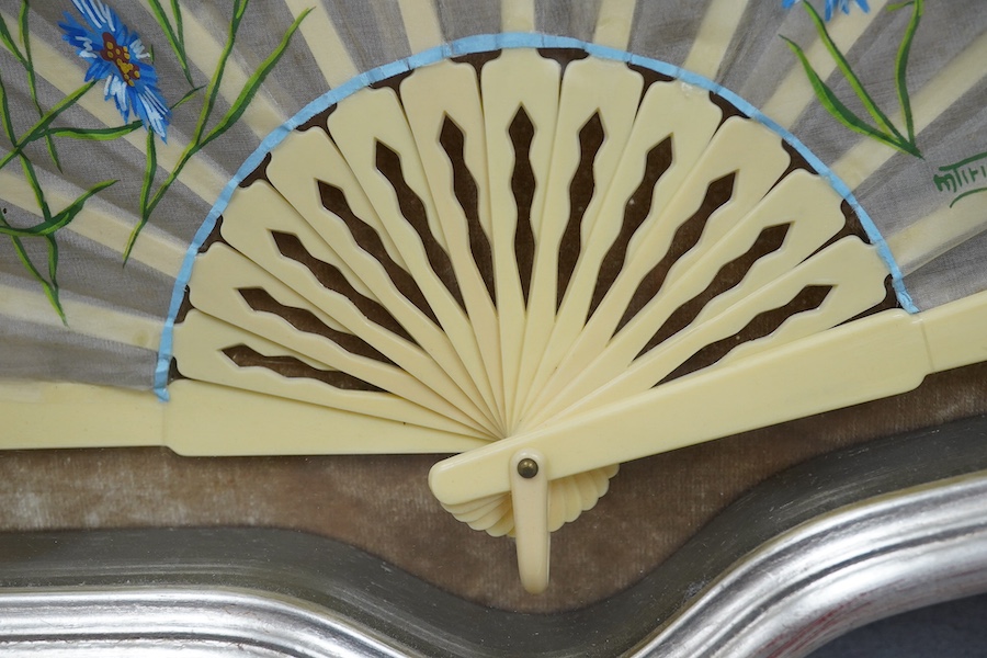 A 20th century silver painted fan case housing a hand painted floral and machine lace fan, case 40cm wide at base. Condition - fan good, case good